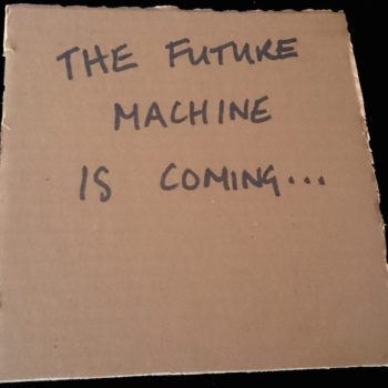 Future Machine is coming... written in black marker on cardboard square