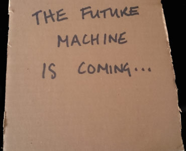 Future Machine is coming... written in black marker on cardboard square