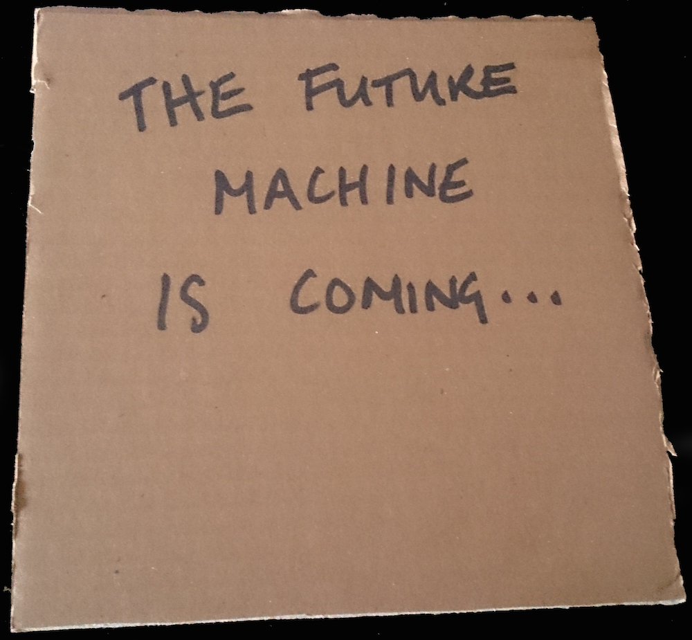 Future Machine is coming... written in black marker on cardboard square