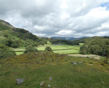 looking across Tilberthwaite valley to the Langdales, cloudy sky with a patch of blue