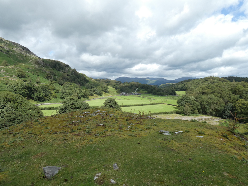 looking across Tilberthwaite valley to the Langdales, cloudy sky with a patch of blue