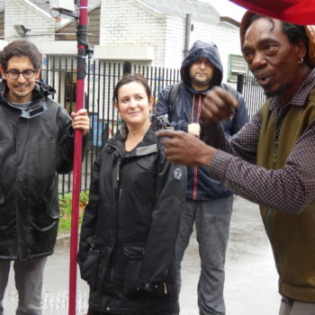 Alex Dayp talking with Rachel Jacobs, Sebastian Gaete holding the weather station pole and Dominic Price - in the rain in Finsbury Park
