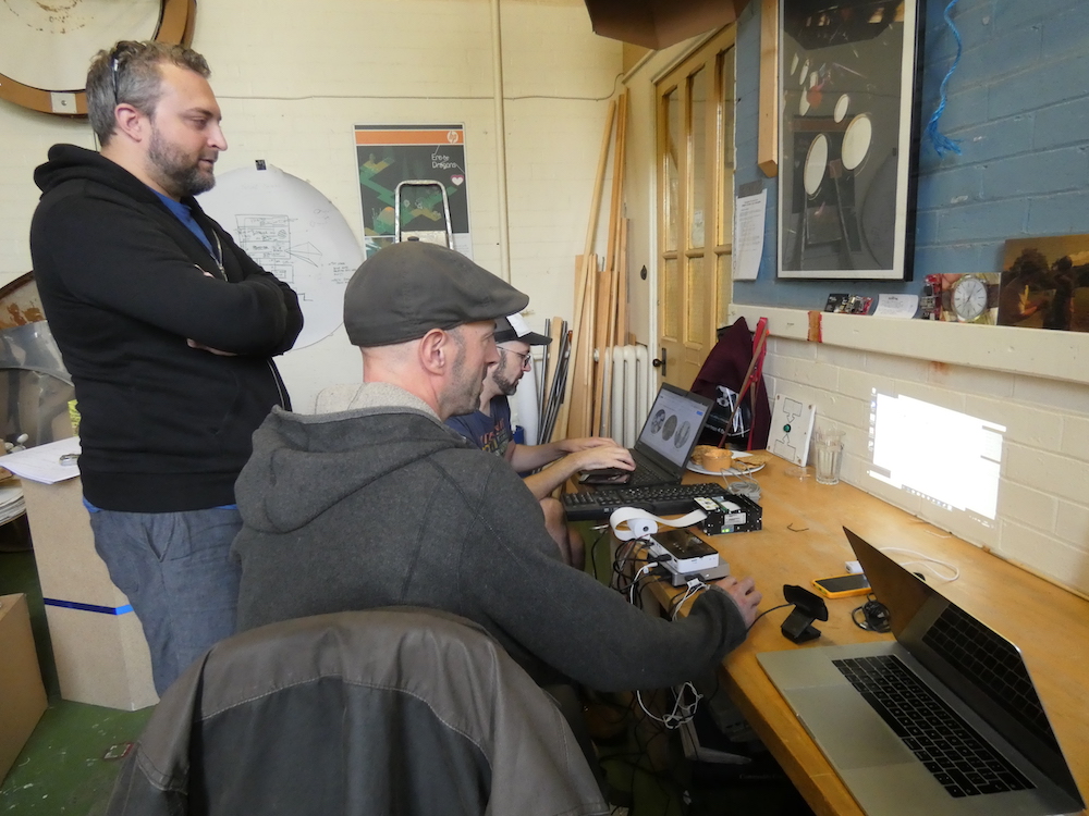 Robin Shackford and Dominic Price working at laptops, with the printer and projector