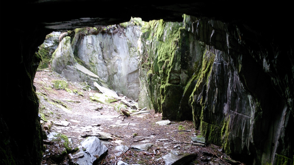 Tilberthwaite Quarry from inside the slate cave with the light and moss outside