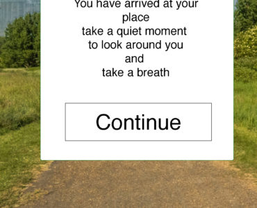 screen shot of mobile app with a message - 'you have arrived at your place take a quiet moment to look around you and take a breath, with a continue button and a path to trees and buildings in the background