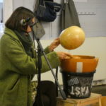 Indira with a water drum in a bucket