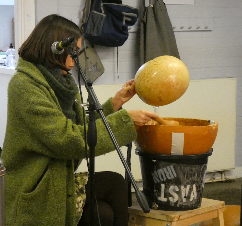 Indira with a water drum in a bucket