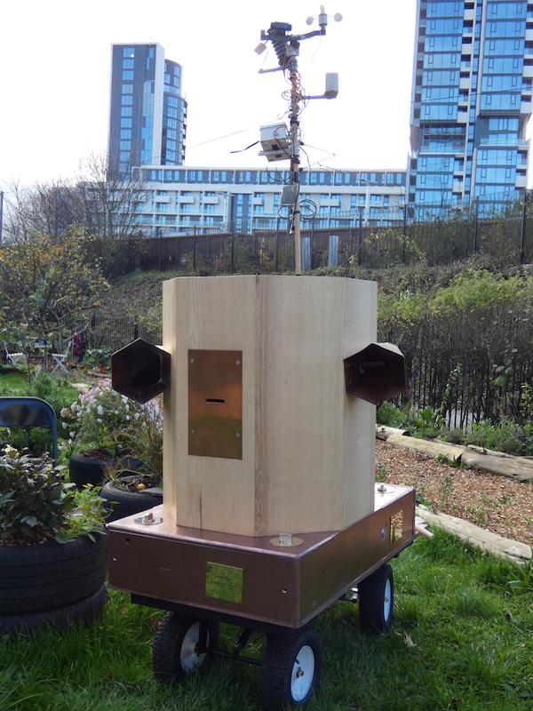 Future Machine and weather station in the drumming school garden with the new large Finsbury Park development in the background