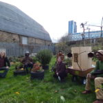 sitting in the drumming school garden from left to right David Kemp, Miles Ncube, Indira Lemouchi, Rachel Jacobs, the Future Machine, Alex Dayo