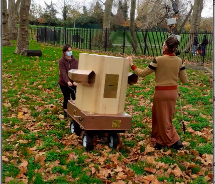 Rachel and Indira pushing the Future Machine up the hill in Finsbury Park amongst Autumn leaves