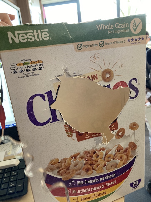 a bird shape cut out of a cheerios cereal packet