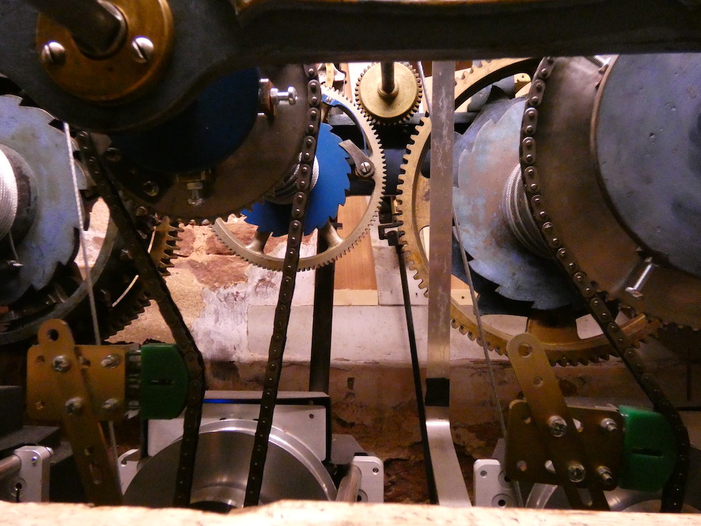 close up of the cogs and parts of the bell clock