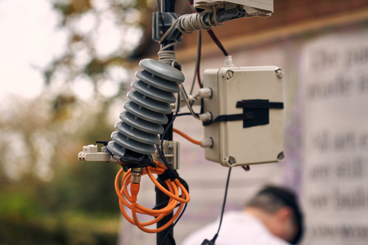 a CO2 monitor, the bottom of the rain sensor and plastic box attached to the weather pole