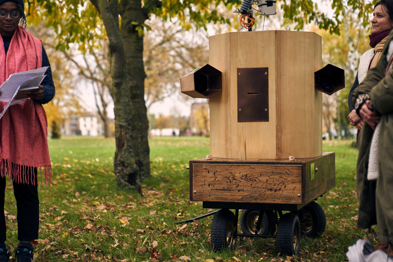 Future Machine with Esi, Rachel and another person standing around, with the park in the backround