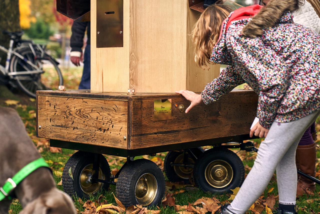 a young girl pressing the button on the side of the Future Machine