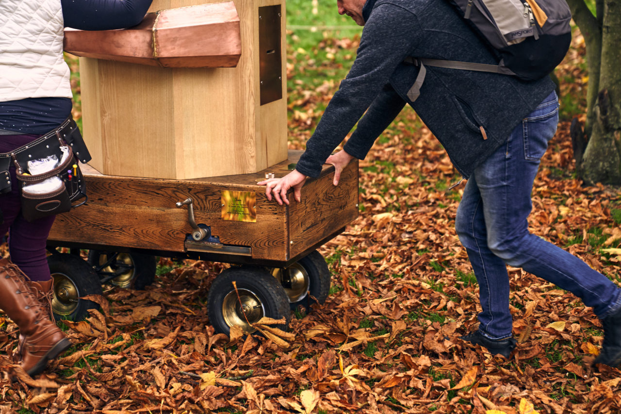 a man pushing the Future Machine through autumn leaves