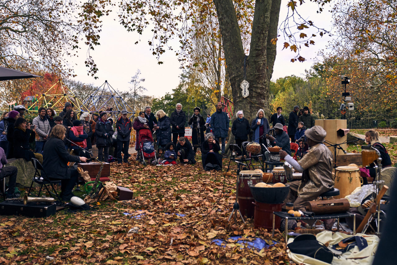 People watching, Future Machine, musicians, autumn leaves, plane tree, playground and trees in the background