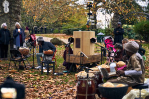 People watching, Future Machine, musicians, autumn leaves, plane tree and trees in the background