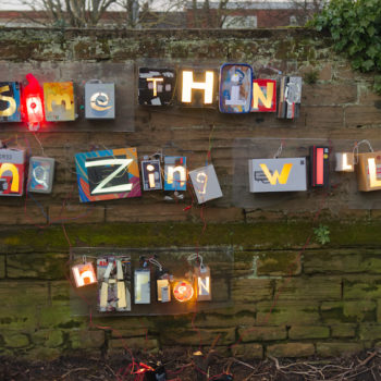 light boxes attached to a wall made from cornflakes with the letters cut out showing 'something amazing will happen'