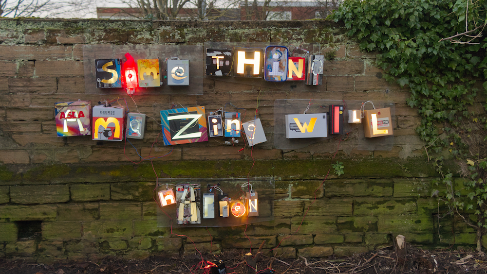 light boxes attached to a wall made from cornflakes with the letters cut out showing 'something amazing will happen'