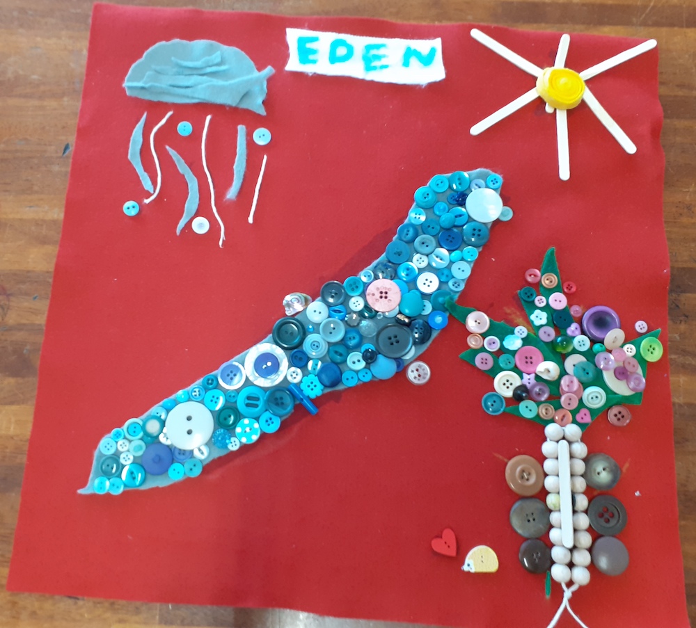 A data map titled Eden made of felt and buttons with a sun, lake, a rain cloud and a tree