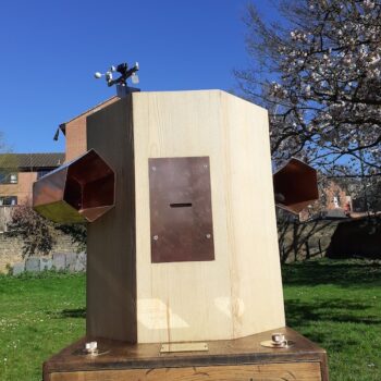 Future Machine against the blue sky with blossoms in the background