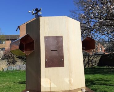 Future Machine against the blue sky with blossoms in the background
