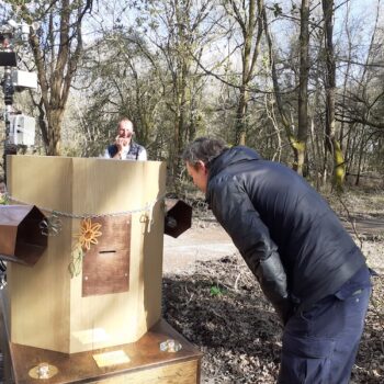 A man bending towards the Future Machine in the woods