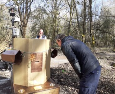 A man bending towards the Future Machine in the woods