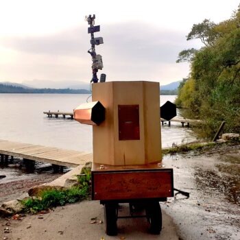 Future Machine by the shores of Lake Windermere at dusk