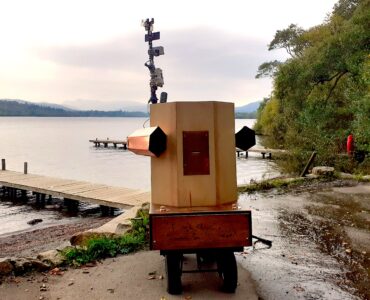 Future Machine by the shores of Lake Windermere at dusk