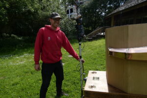Man in a cap and national trust hoodie holding the lever on the back of Future Machine