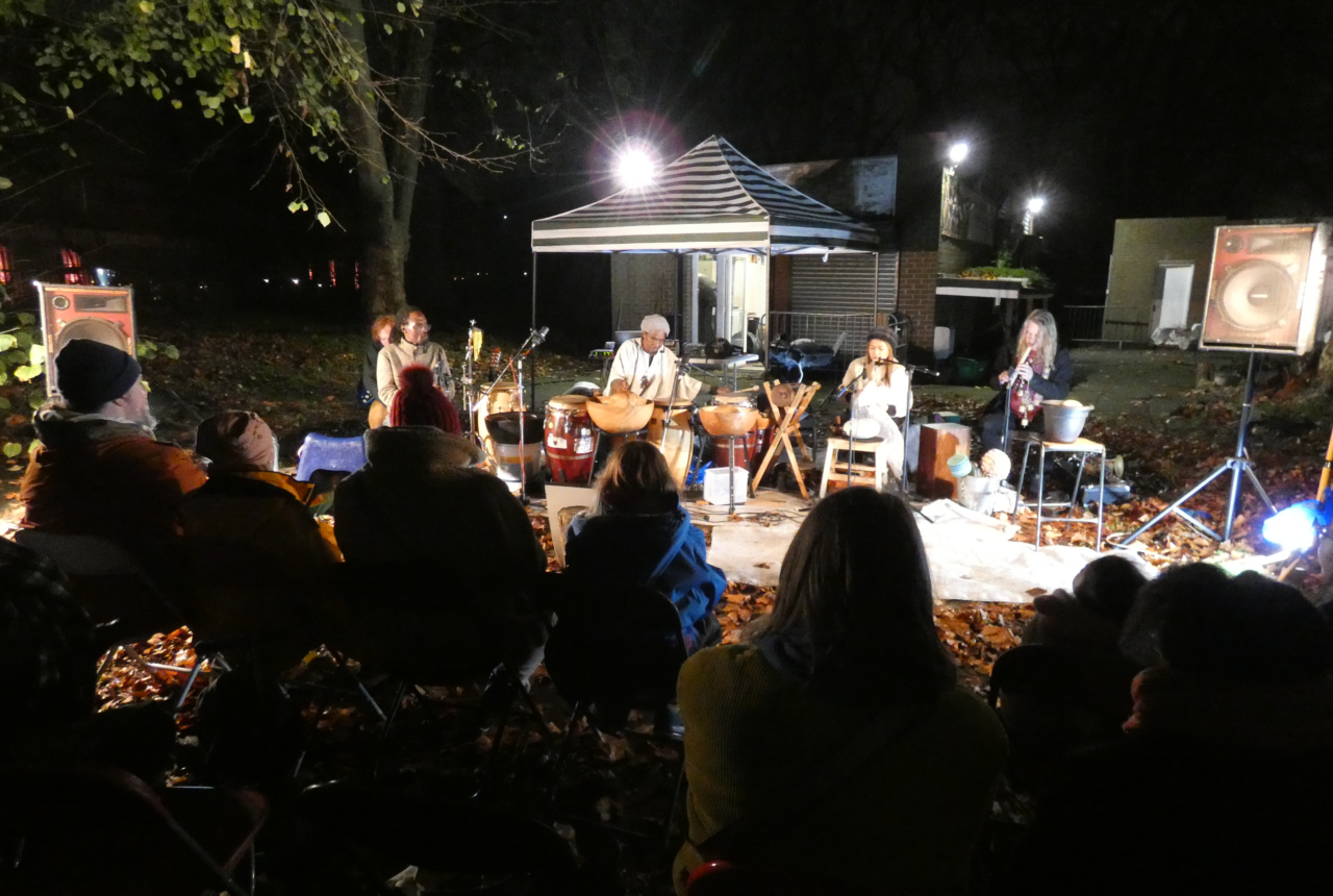 The Rainmakers playing music and audience sitting in front