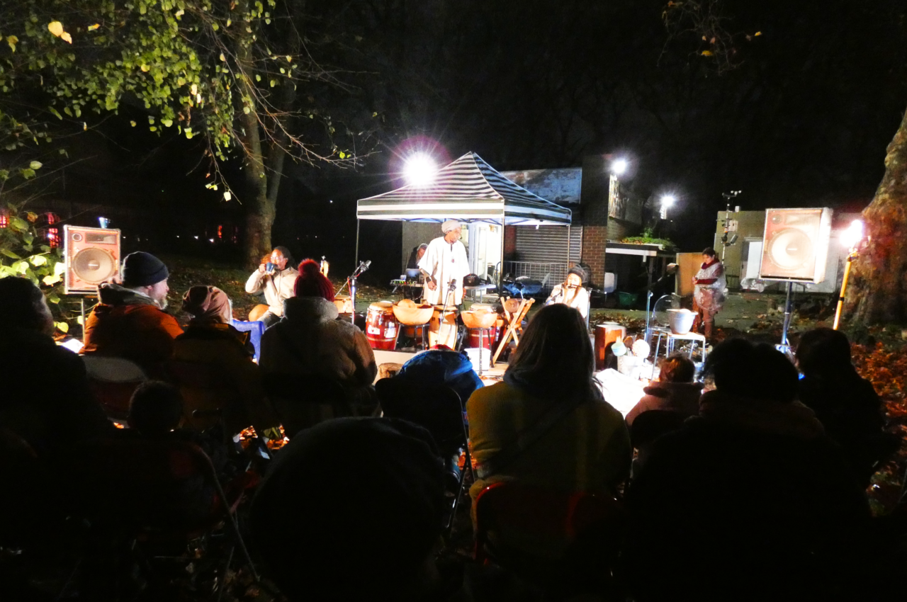 The Rainmakers playing music and audience sitting in front